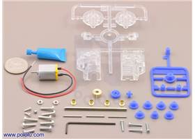 Parts included with the Tamiya 70189 mini motor low-speed gearbox (4-speed) kit with quarter for size reference