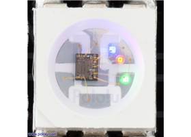 Close up of an APA102C, with the red, green, and blue LEDs on at a low brightness