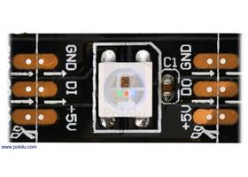 Close up of one segment of a WS2812B-based LED strip, with the red, green, and blue LEDs on at their dimmest setting