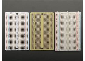 Top and bottom view of the Adafruit Perma-Proto Half-Sized Breadboard PCB next to a standard half-sized bead board