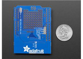 Bottom view of the Adafruit Data Logging Shield for Arduino next to US quarter dollar for size reference.