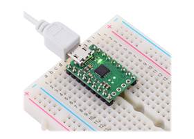 CP2102N USB-to-serial adapter carrier in a breadboard with included 0.1″ male headers installed.