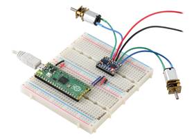 A Raspberry Pi Pico on a breadboard using a Motoron M2T256/M2U256 Dual Motor Controller to control two motors.