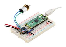A Raspberry Pi Pico on a breadboard using a Motoron M1T256/M1U256 Motor Controller to control a motor.