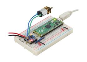 A Raspberry Pi Pico on a breadboard using a Motoron M1T550/M1U550 Motor Controller to control a motor.