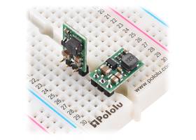 D24V7Fx step-down voltage regulators, soldered with straight and right-angle headers (not included), on a breadboard.