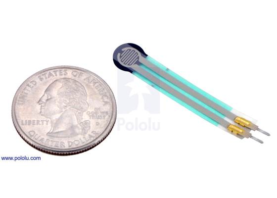 Force-sensing resistor (0.2″ circle) with US quarter for size reference.