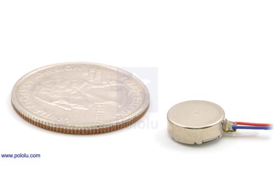 Shaftless vibration motor 10&#215;3.4mm with quarter for size reference.