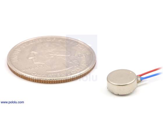 Shaftless vibration motor 8&#215;3.4mm with quarter for size reference.