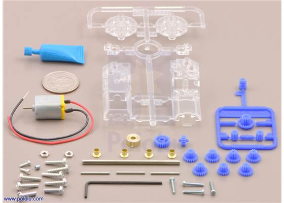 Parts included with the Tamiya 70188 mini motor gearbox (8-speed) kit with quarter for size reference.