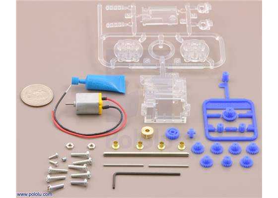 Parts included with the Tamiya 70190 mini motor multi-ratio gearbox (12-speed) kit with quarter for size reference.