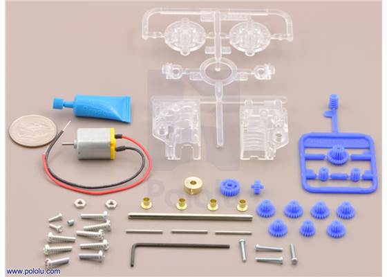 Parts included with the Tamiya 70189 mini motor low-speed gearbox (4-speed) kit with quarter for size reference.
