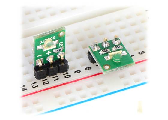 QTR-L-1A and QTR-L-1RC reflectance sensors plugged into a breadboard in two possible orientations.