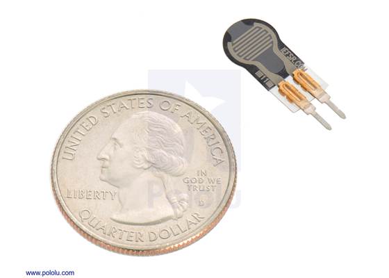 Force-sensing resistor (0.25″-diameter circle, short tail) with a US quarter for size reference.