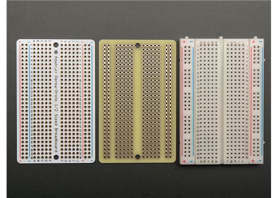 Top and bottom view of the Adafruit Perma-Proto Half-Sized Breadboard PCB next to a standard 400-pt bread board.