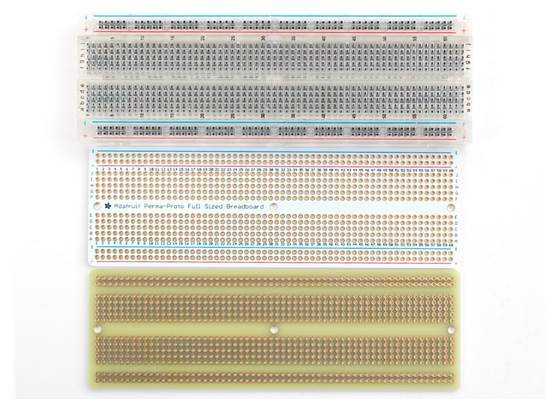 Top and bottom view of the Adafruit Perma-Proto Full-Sized Breadboard PCB next to a standard full-sized breadboard.