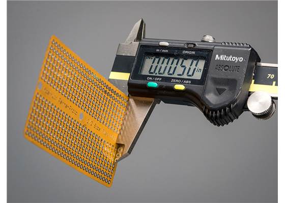 Adafruit Flex Perma-Proto Half-Sized Breadboard Flex-PCB with calipers showing its thickness.