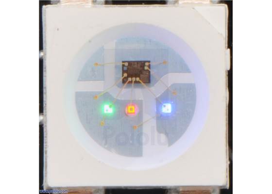Close up of an SK6812, with the red, green, and blue LEDs on at their dimmest setting.