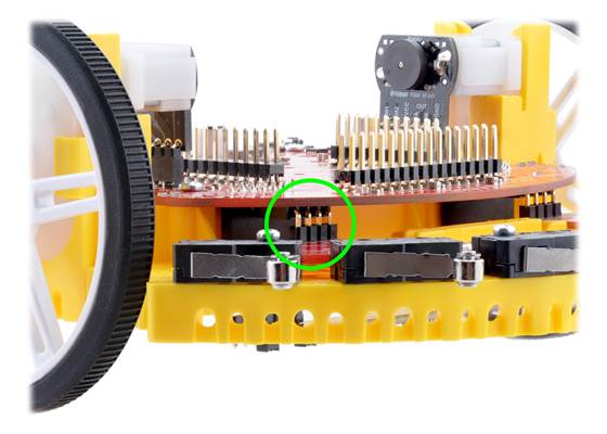 Close-up view of Bumper Switch Assembly male header pins plugged into the female header on the Chassis Board.