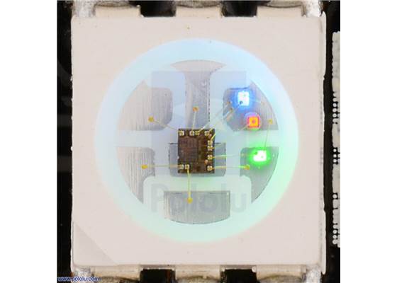 Close up of an SK9822, with the red, green, and blue LEDs on at a low brightness.