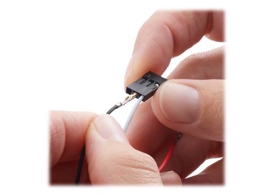 Inserting the pre-crimped cable wires into the 1×3 housing.